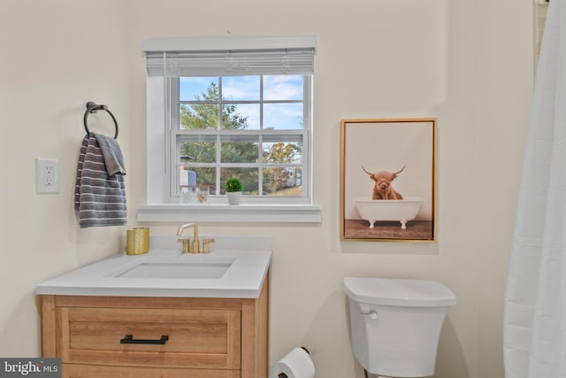 bathroom featuring vanity and toilet