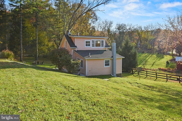 rear view of property with a lawn