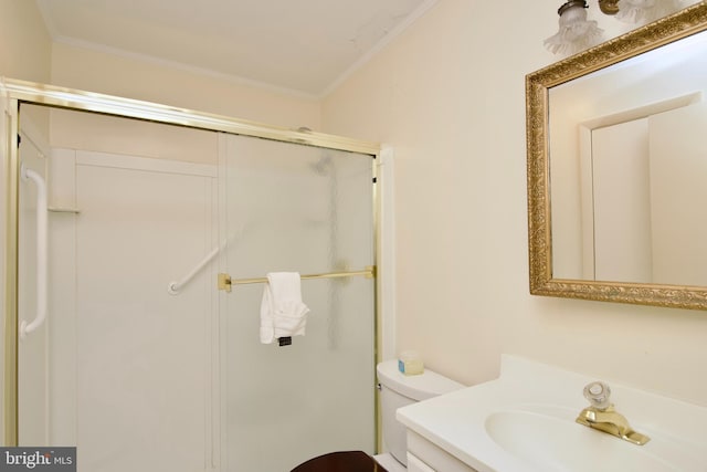 bathroom featuring vanity, crown molding, a shower with shower door, and toilet