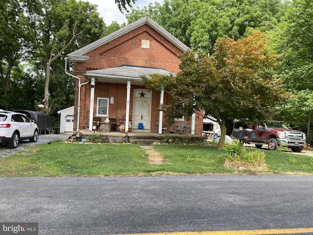 view of front of house with a front yard and covered porch