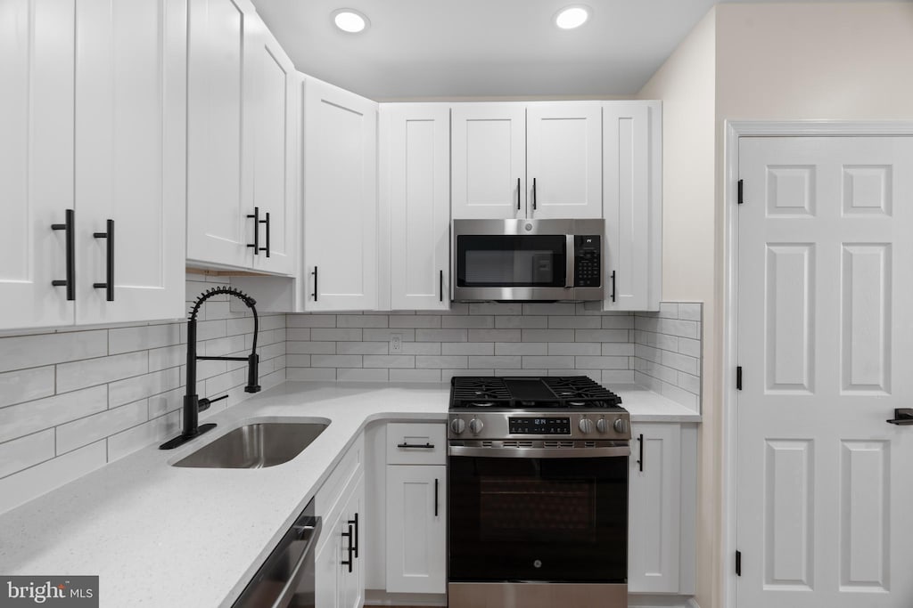 kitchen featuring white cabinetry and stainless steel appliances