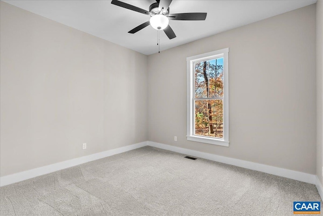 carpeted empty room featuring ceiling fan and a healthy amount of sunlight