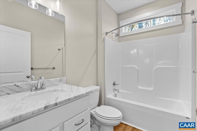 full bathroom with toilet, vanity, shower / bathing tub combination, and hardwood / wood-style flooring