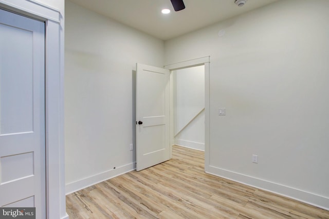 spare room featuring light wood-type flooring and ceiling fan