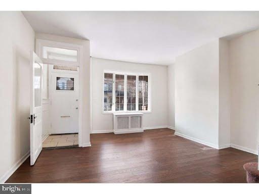 entryway with dark wood-type flooring and a wealth of natural light