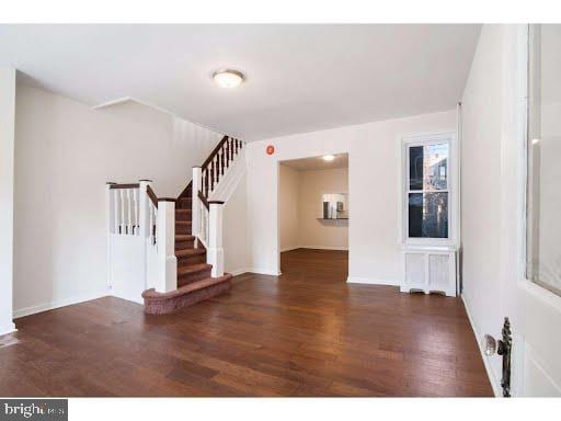 interior space with radiator and dark wood-type flooring