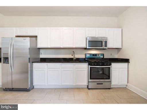 kitchen featuring sink, white cabinets, and stainless steel appliances