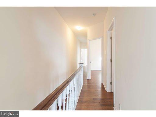 hallway with dark hardwood / wood-style floors