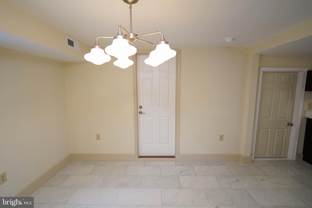 unfurnished room with a chandelier, visible vents, marble finish floor, and baseboards