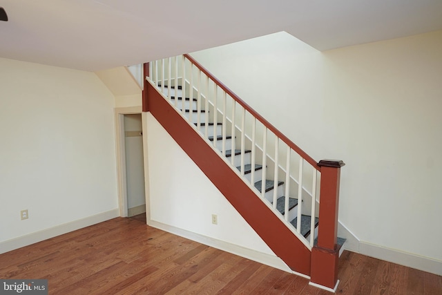 stairway with hardwood / wood-style flooring