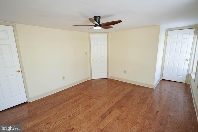 empty room with ceiling fan and hardwood / wood-style floors