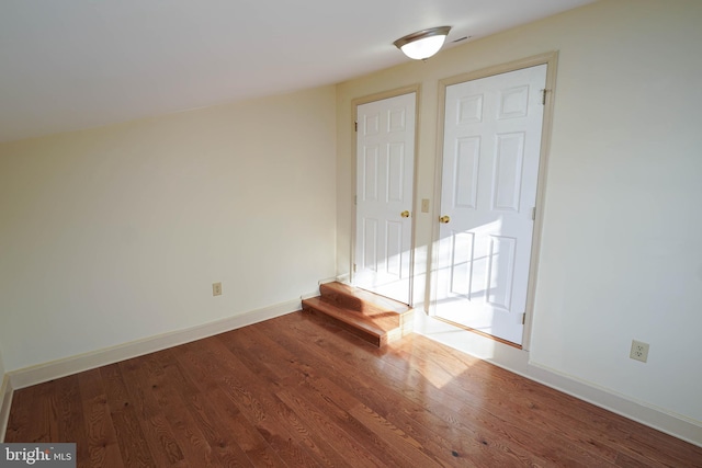 spare room featuring wood-type flooring