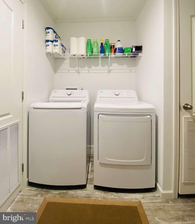 clothes washing area featuring separate washer and dryer