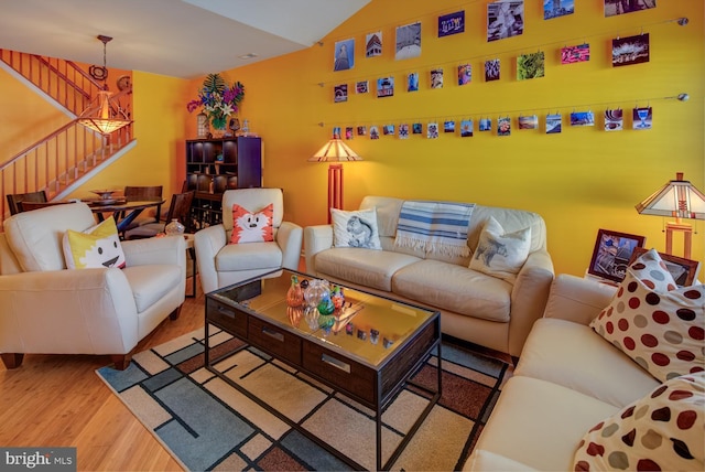 living room with light hardwood / wood-style floors and lofted ceiling