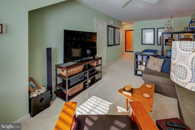 living room with ceiling fan and light colored carpet