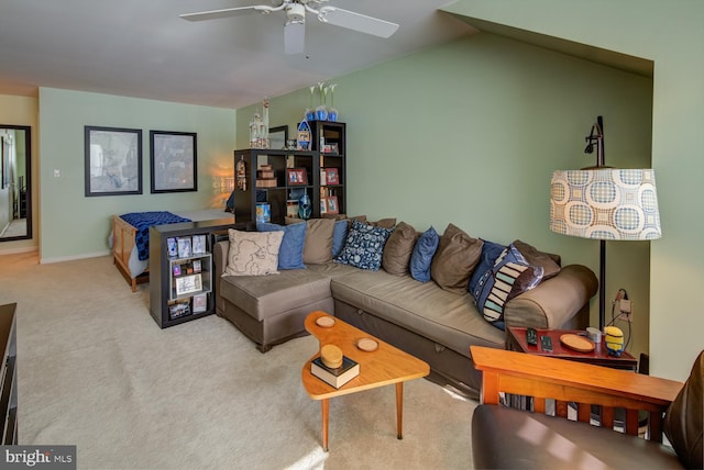 carpeted living room with ceiling fan