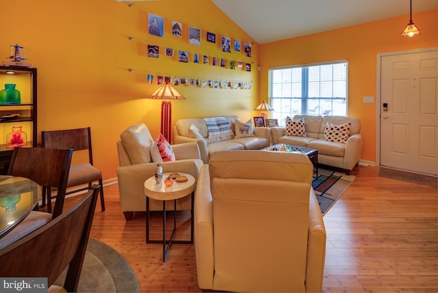 living room featuring light hardwood / wood-style flooring and vaulted ceiling