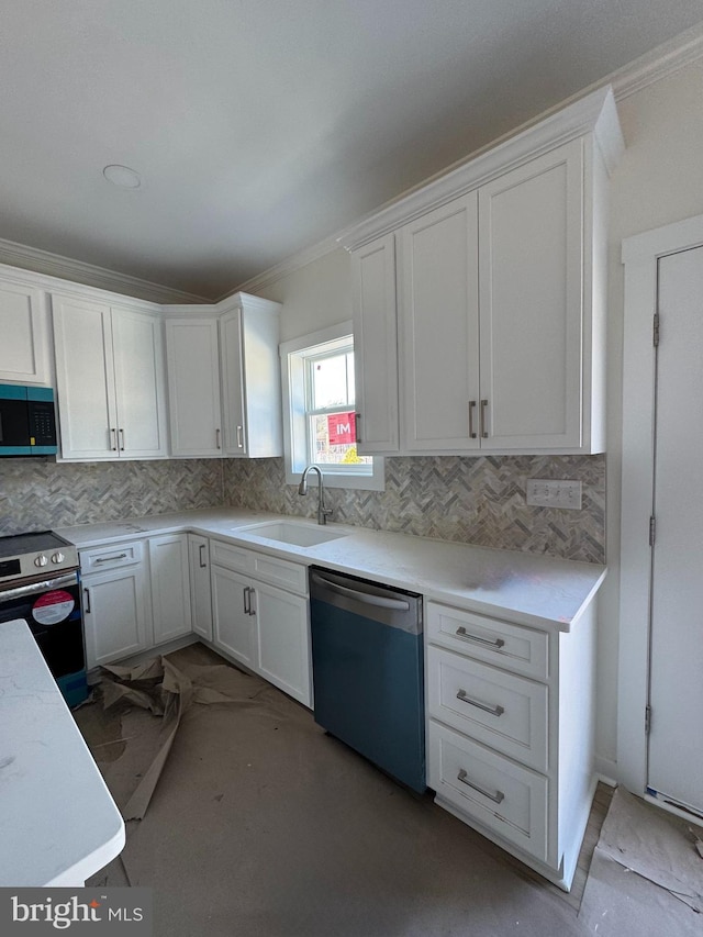 kitchen with tasteful backsplash, appliances with stainless steel finishes, sink, and white cabinets