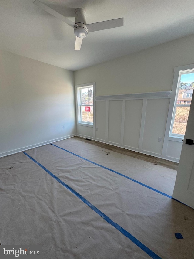 empty room featuring light colored carpet and ceiling fan