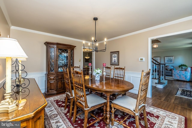 dining area with a notable chandelier, crown molding, and dark wood-type flooring