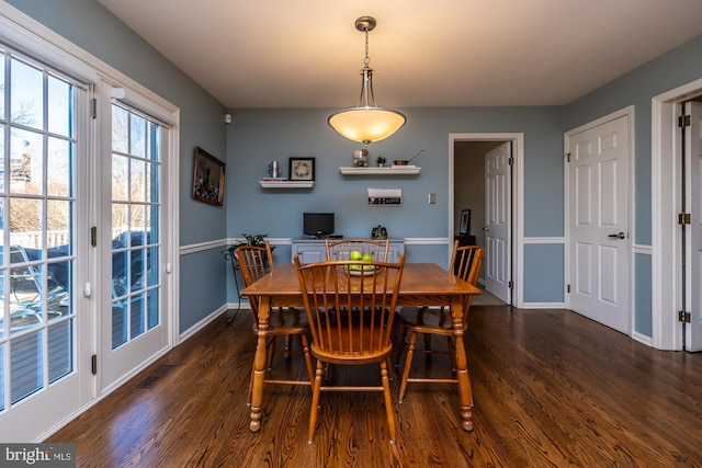 dining space with dark hardwood / wood-style flooring