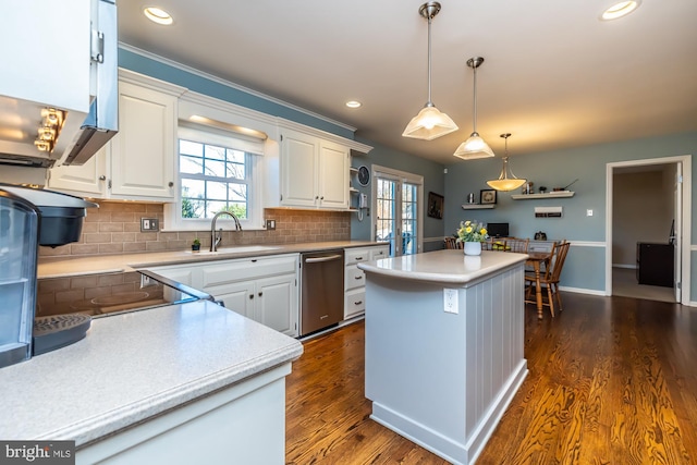 kitchen featuring dark hardwood / wood-style floors, white cabinetry, sink, a center island, and stainless steel dishwasher