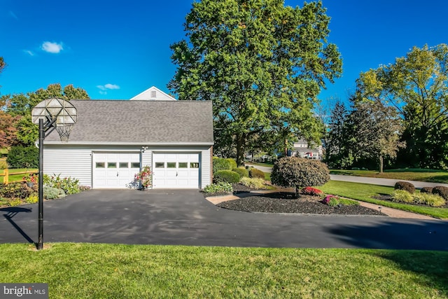 view of side of home with a yard and a garage