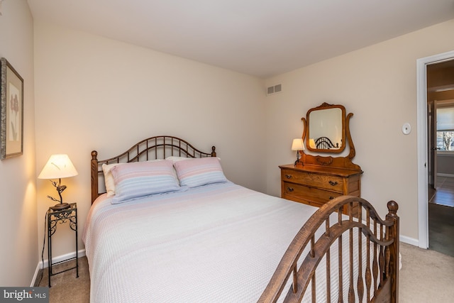 bedroom featuring light colored carpet