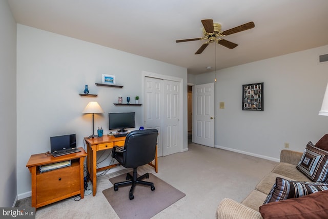 carpeted office space with ceiling fan