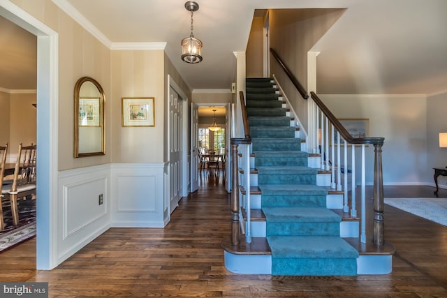 interior space featuring ornamental molding and dark hardwood / wood-style floors