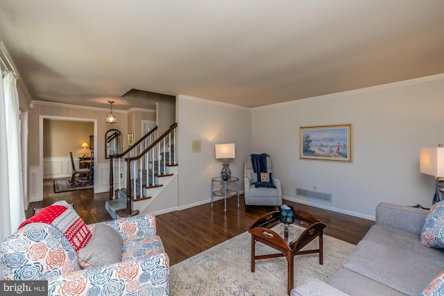 living room featuring crown molding and dark hardwood / wood-style flooring