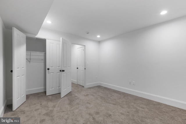 unfurnished bedroom with light colored carpet