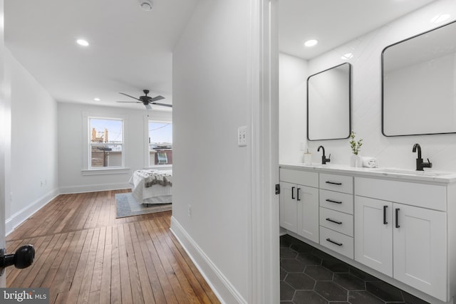 bathroom featuring ceiling fan, hardwood / wood-style flooring, and vanity