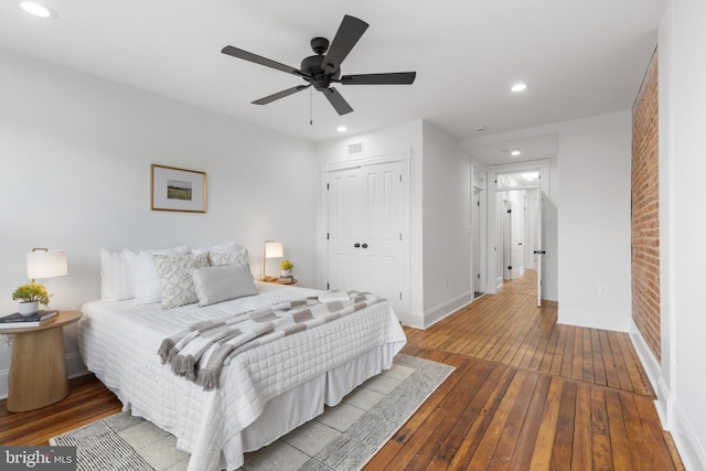 bedroom featuring ceiling fan, a closet, and wood-type flooring