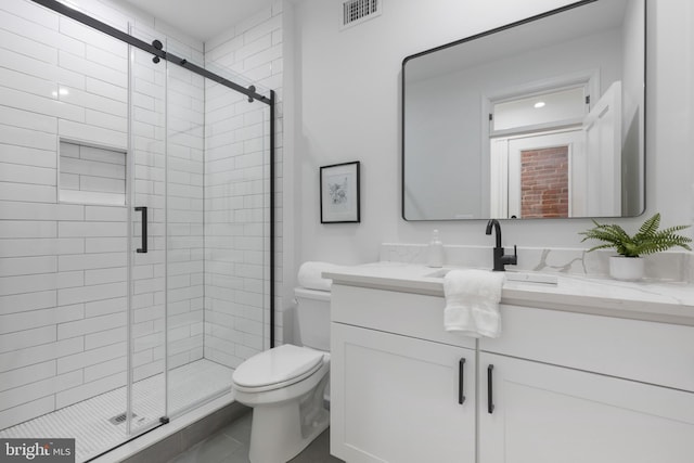 bathroom with toilet, walk in shower, and vanity