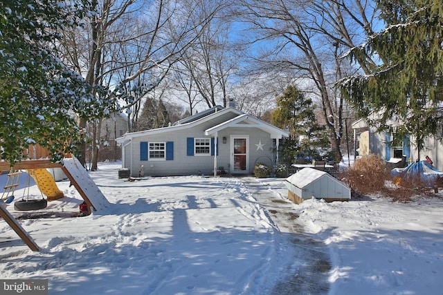 view of front of home featuring a playground and central air condition unit