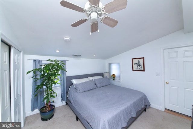 bedroom with ceiling fan, light carpet, and vaulted ceiling