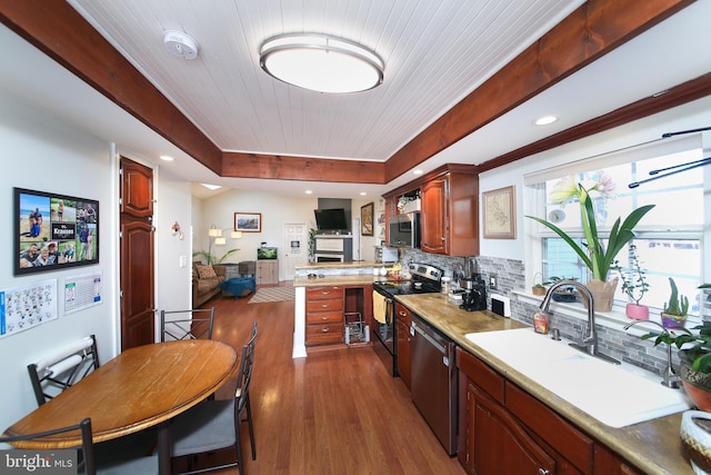 kitchen with appliances with stainless steel finishes, wood ceiling, dark hardwood / wood-style flooring, sink, and backsplash