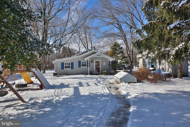 view of front of property with a playground