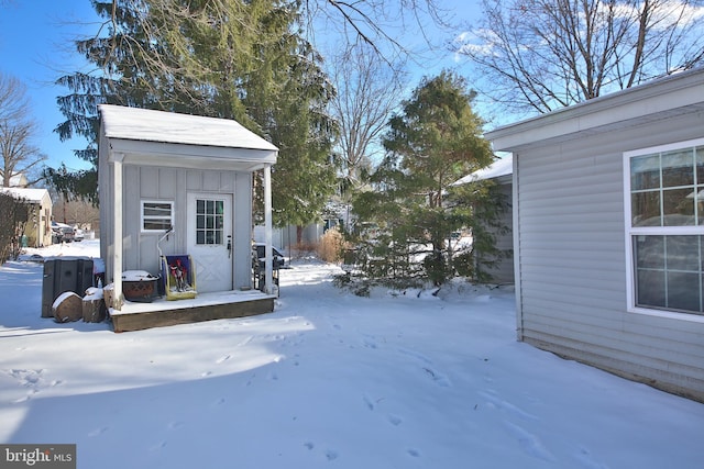 yard covered in snow with an outdoor structure