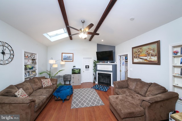 living room featuring ceiling fan, lofted ceiling with beams, and hardwood / wood-style flooring