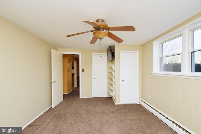 unfurnished bedroom with light carpet, a baseboard radiator, and ceiling fan