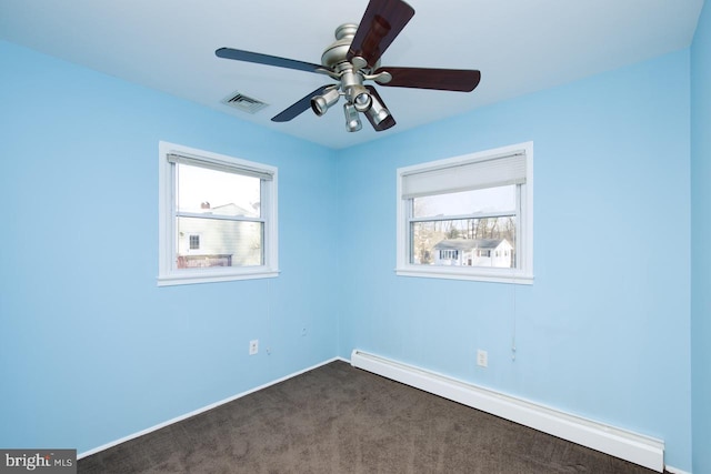 carpeted spare room with ceiling fan and baseboard heating