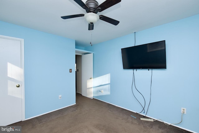 unfurnished bedroom featuring dark colored carpet and ceiling fan