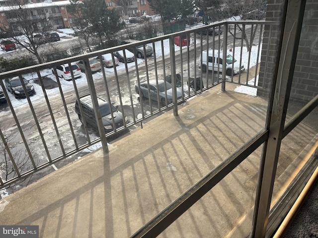 view of snow covered back of property