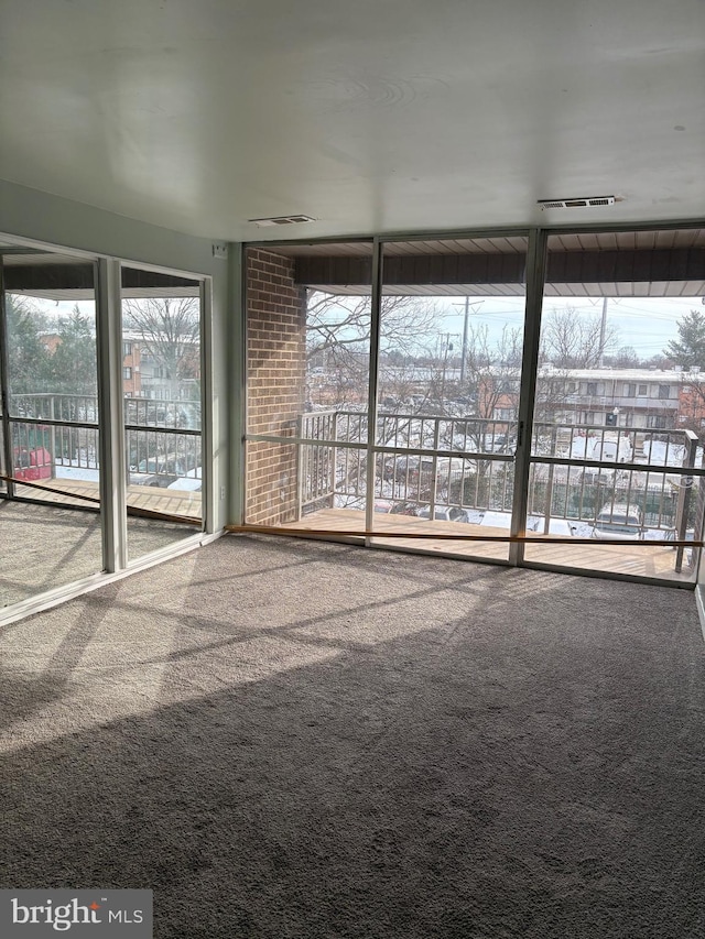 carpeted spare room with plenty of natural light