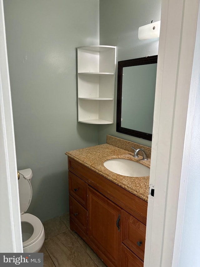 bathroom with vanity, tile patterned floors, and toilet