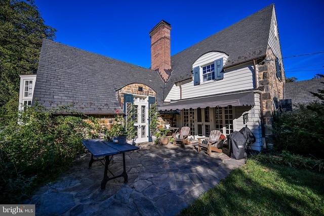 back of property featuring french doors and a patio area