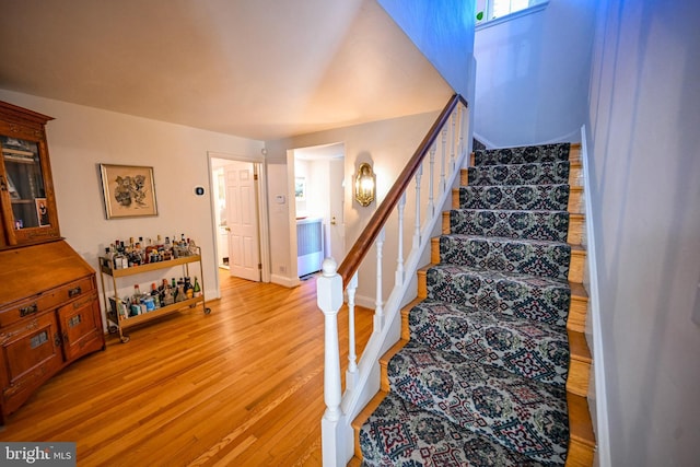 stairs featuring hardwood / wood-style flooring