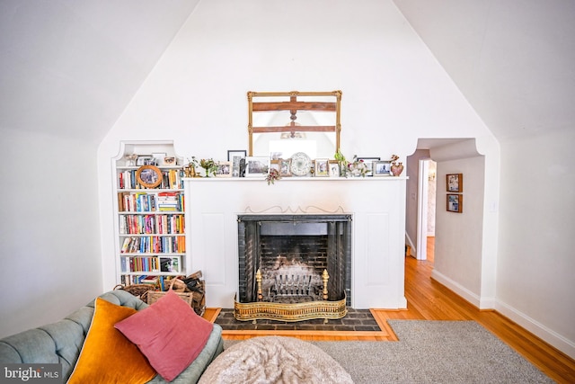 living room with hardwood / wood-style flooring and high vaulted ceiling